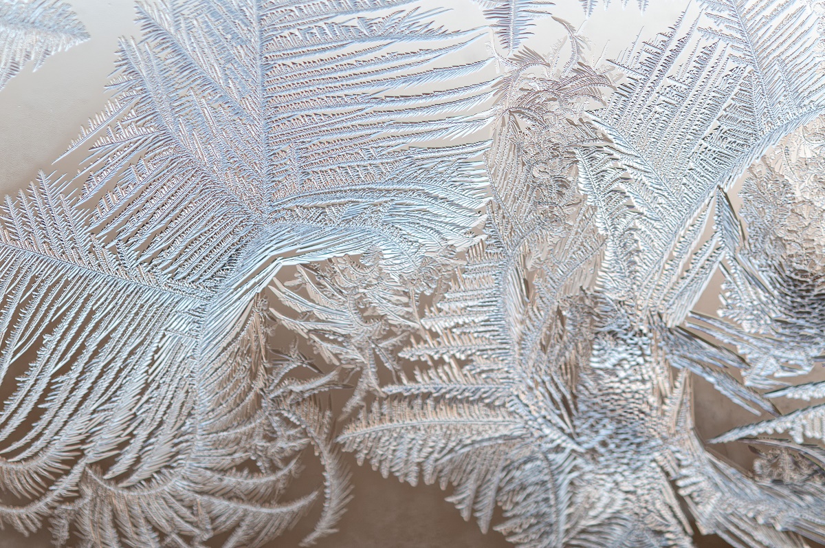 Ice floral pattern on glass in blurred vignette macro view