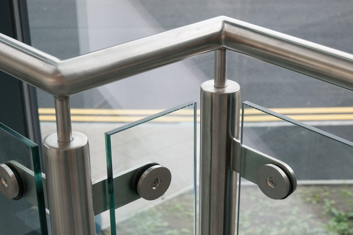 Sturdy silver metal handrail with glass in between